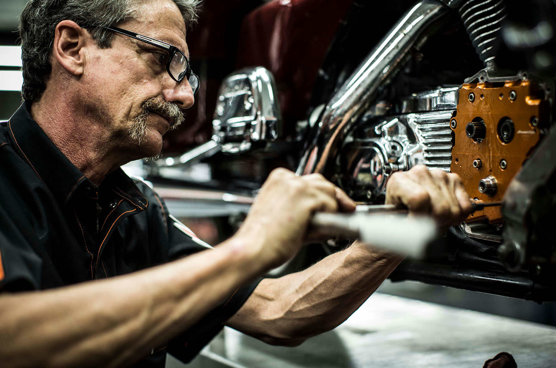 Harley-Davidson Mechanic Working on a engine 